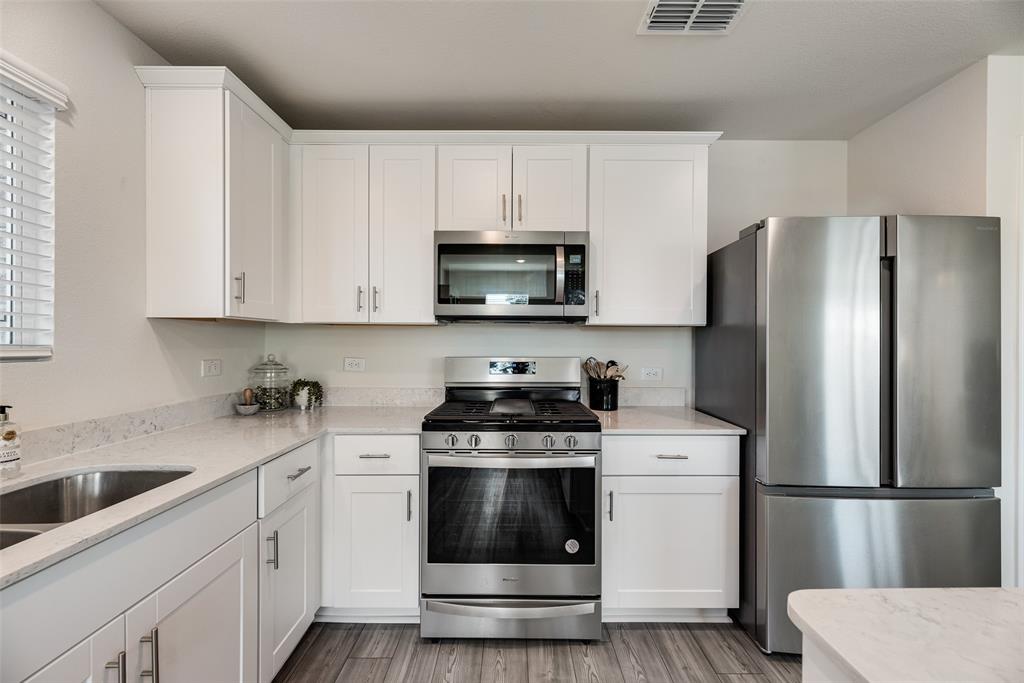 7005 Adderly Road Pilot Point, TX 76258 - Photo 2 of 38 Stainless steel appliances, gas stove with griddle and chrome finishes elevates this kitchen