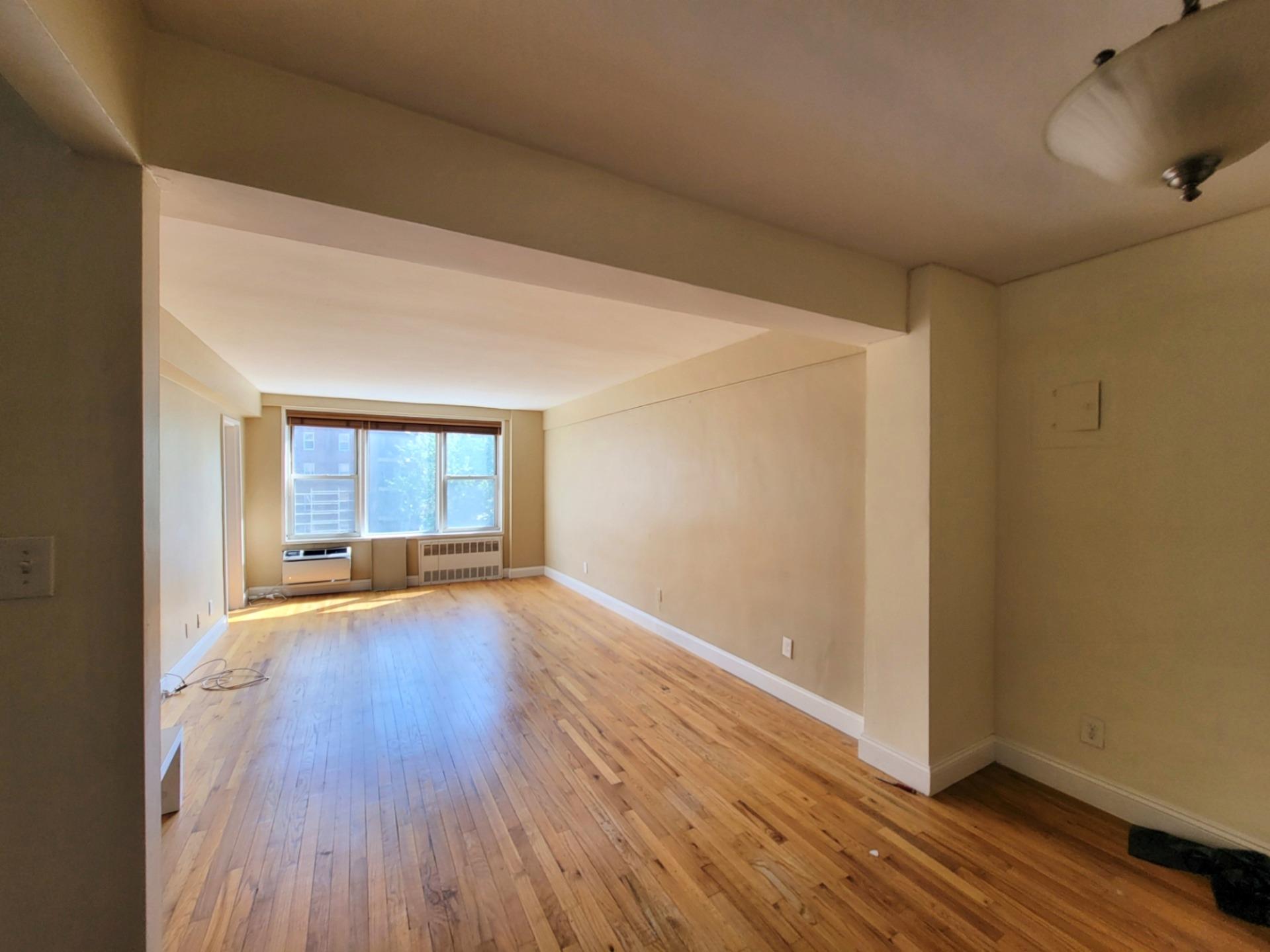 2736 Independence Avenue, Unit 4C Bronx, NY 10463 - Photo 5 of 8 Spare room featuring radiator heating unit, light wood-style flooring, and baseboards