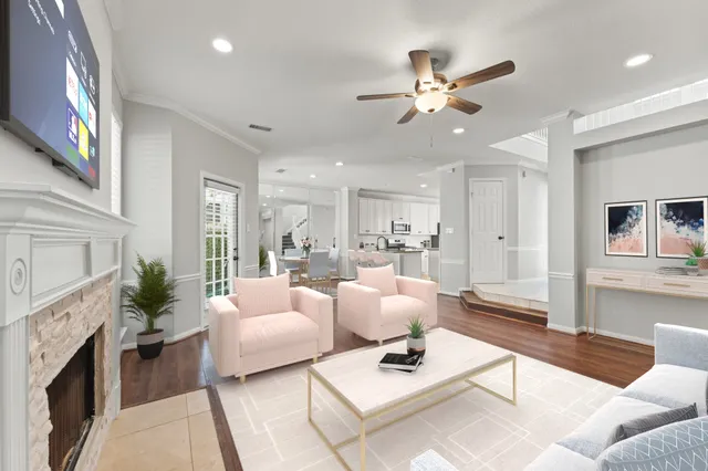 a living room with furniture chandelier and a fireplace