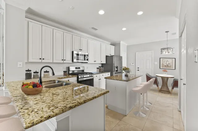 a view of a patio with table and chairs near a barbeque