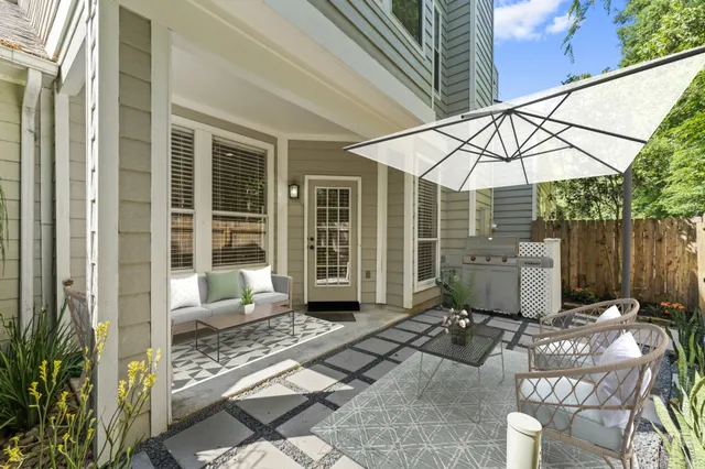 a kitchen with stainless steel appliances granite countertop a stove top oven a sink a refrigerator and white cabinets with wooden floor