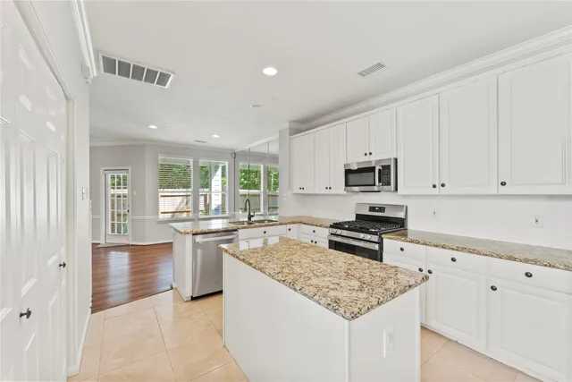 a kitchen with a refrigerator a stove top oven a sink and dishwasher