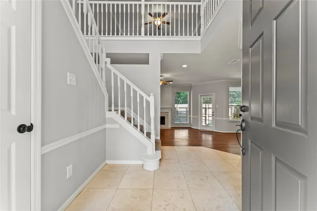 a view of a hallway with bedroom and windows
