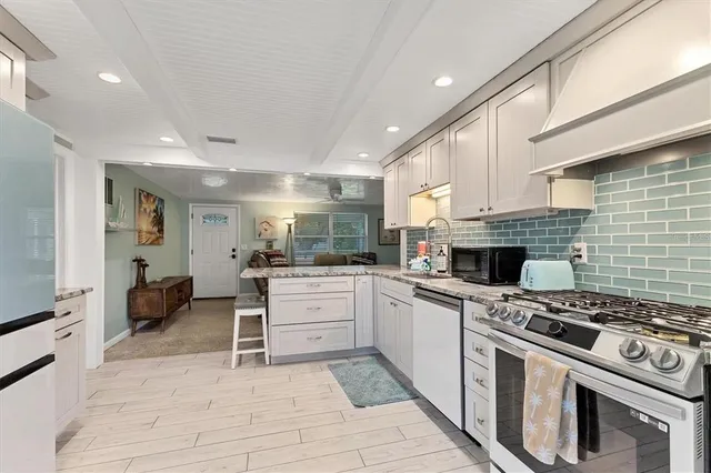a kitchen with a stove and a refrigerator