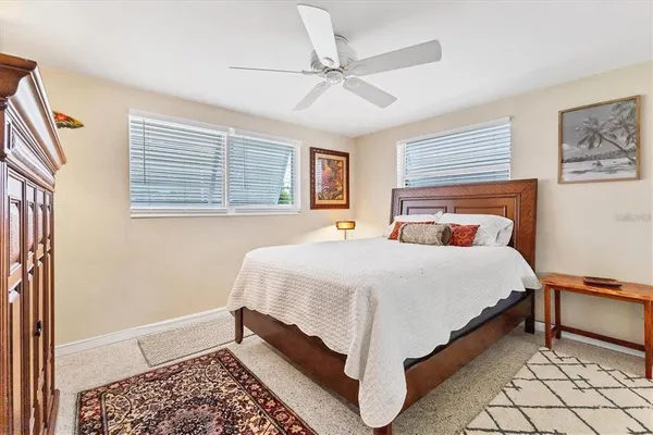 a bedroom with a bed rug and window