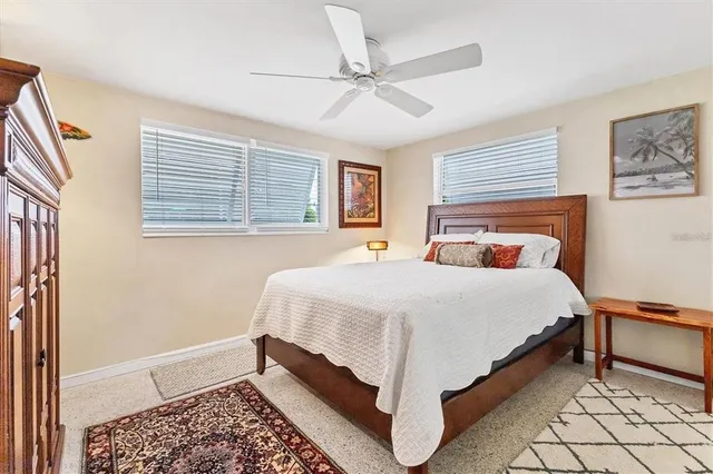 a bedroom with a bed rug and window