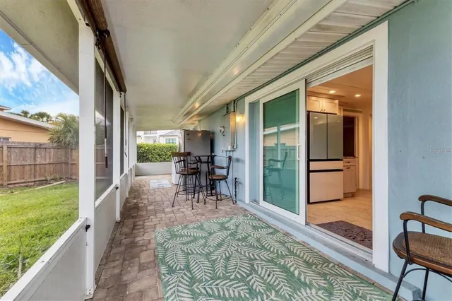 a view of a porch with chairs and backyard
