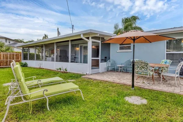 a view of a house with backyard porch and sitting area