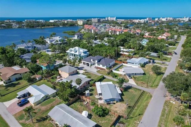 an aerial view of a houses with outdoor space and swimming pool