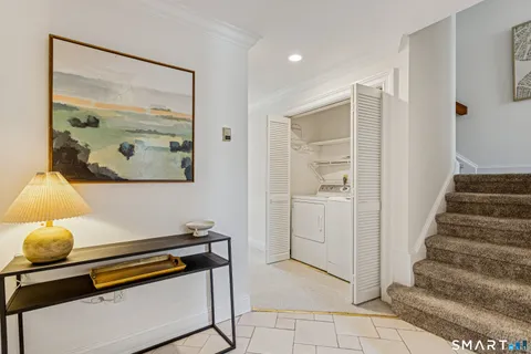 a room with stairs and a painting on the wall