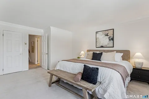 a bedroom with a bed and a lamp