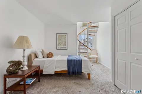a bedroom with furniture and a window
