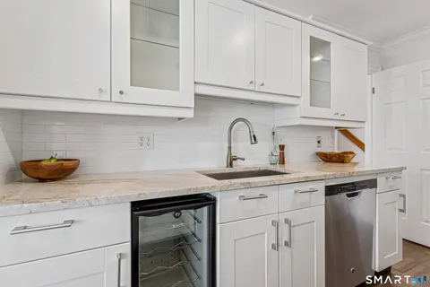 a kitchen with white cabinets and a sink