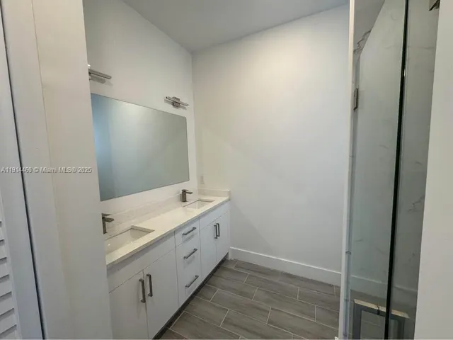 a bathroom with a double vanity sink and mirror