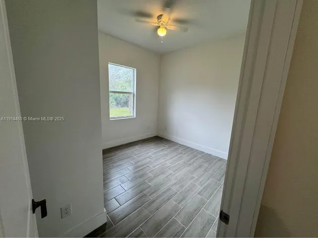an empty room with windows and closet