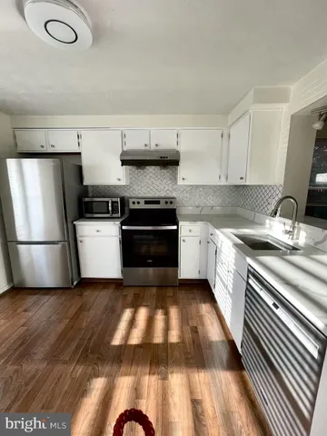 a view of bathroom with granite countertop window
