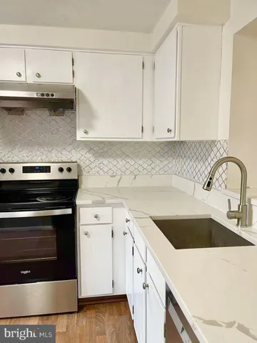 a view of a kitchen with a fridge and a window