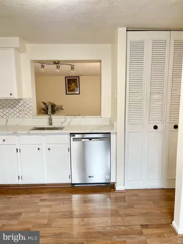 a view of washer and dryer with wooden floor