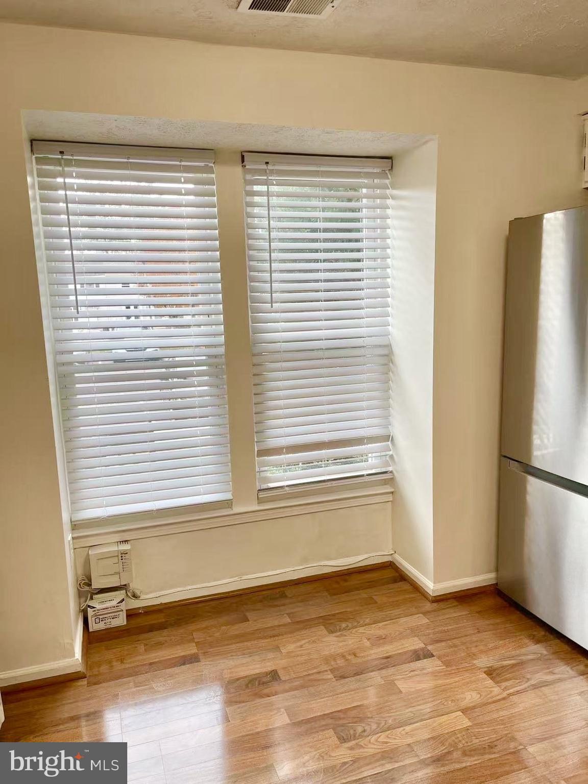 6712 Quiet Hours Columbia, MD 21045 - Photo 16 of 38 a view of a kitchen with a fridge and a window