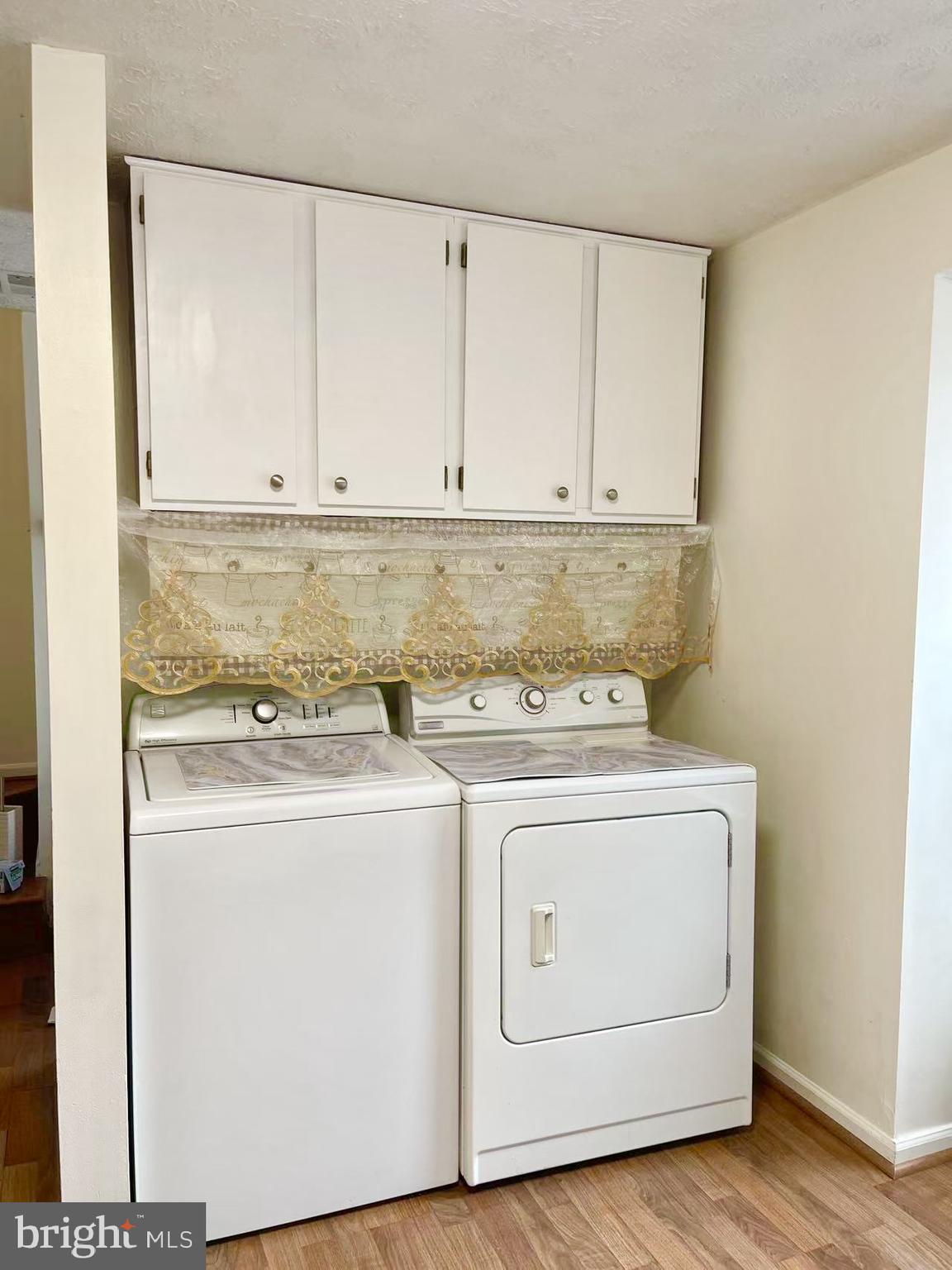 6712 Quiet Hours Columbia, MD 21045 - Photo 17 of 38 a view of washer and dryer with wooden floor