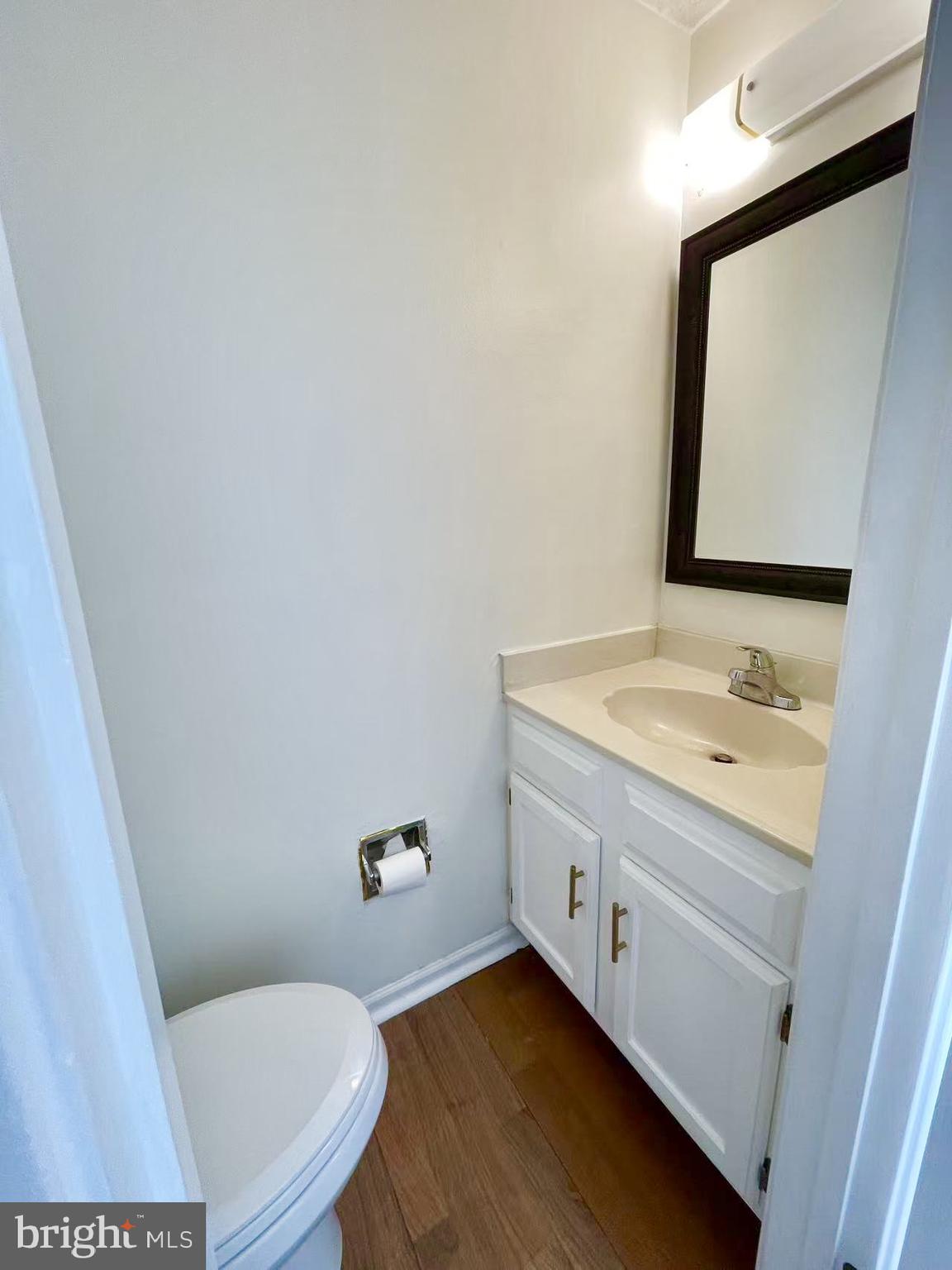 6712 Quiet Hours Columbia, MD 21045 - Photo 18 of 38 a bathroom with a granite countertop toilet sink and mirror