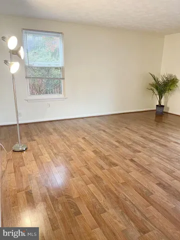 a view of an empty room and wooden floor