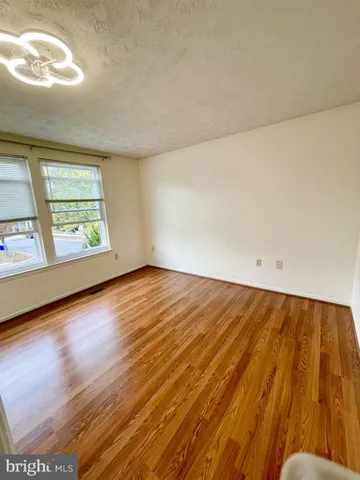 a view of a backyard with wooden fence and a bench