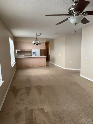 a view of a kitchen with a sink and a chandelier fan