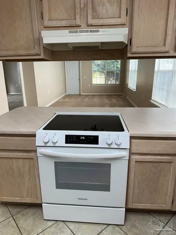 a stove top oven sitting inside of a kitchen
