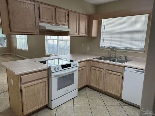 a kitchen with a sink stove and cabinets