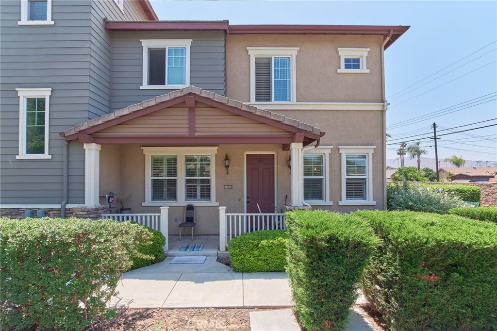 a front view of a house with garden and porch