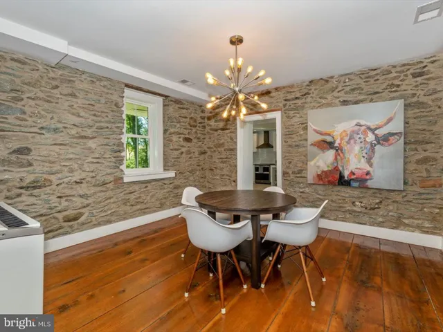 a large kitchen with stainless steel appliances a stove a sink and a refrigerator