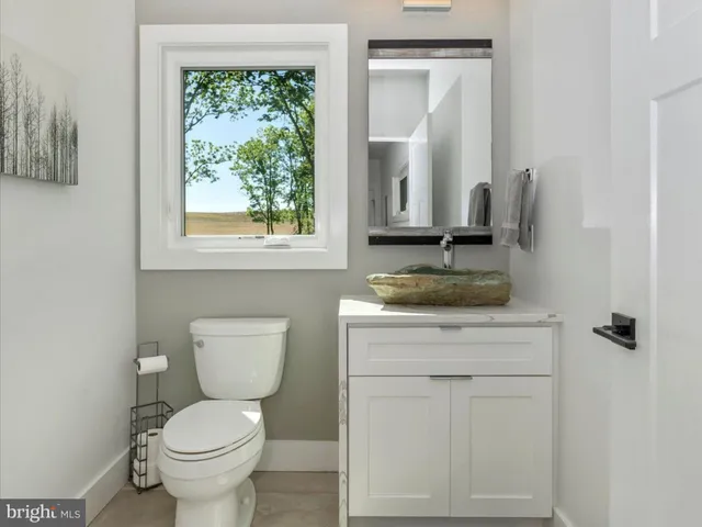 a spacious bedroom with a large bed and a chandelier