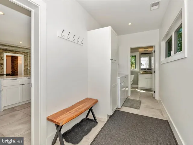 a bed sitting in a spacious bedroom next to a window