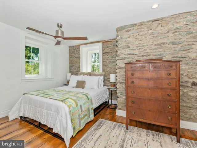a living room with patio furniture and a potted plant