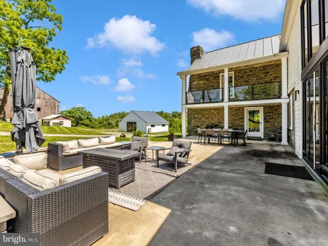a view of backyard with barbeque grill and outdoor seating