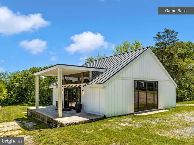 an aerial view of lake residential house with swimming pool and green space