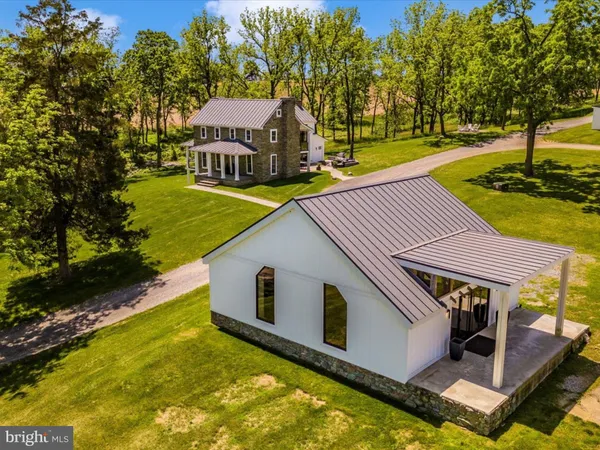 a front view of a house with a yard table and chairs