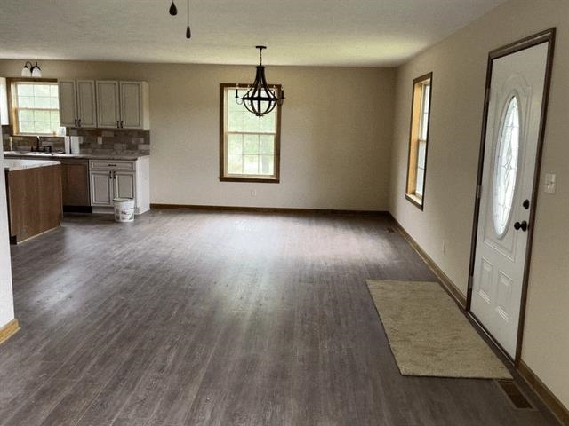 370 Walnut Grove Road Bolivar, TN 38008 - Photo 8 of 16 an empty room with wooden floor cabinet and front door