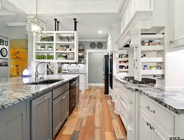 a kitchen with stainless steel appliances granite countertop a lot of counter top space and cabinets