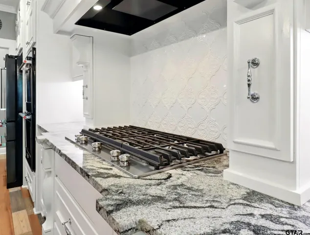 a kitchen with a stove and a shower