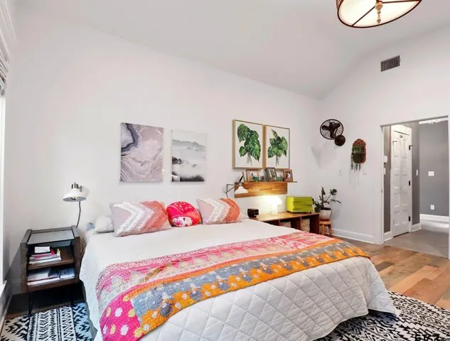 a bedroom with a bed and a chandelier