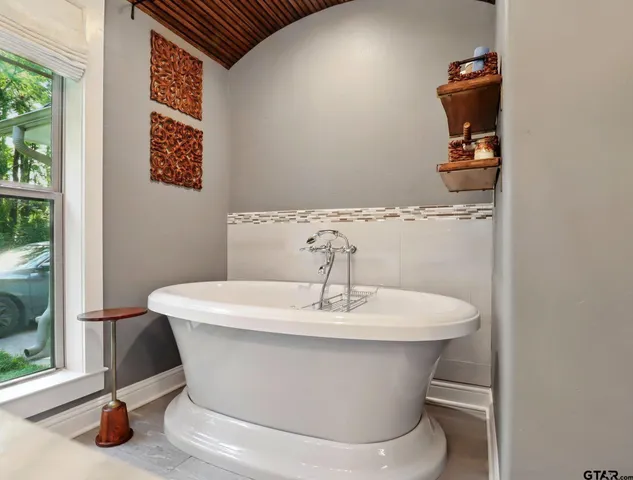 a white bath tub sitting next to a white sink