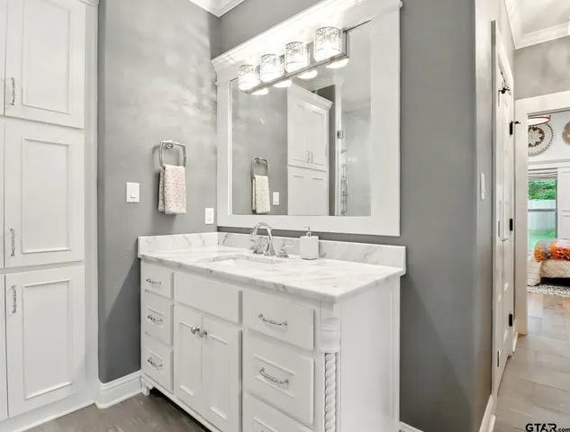 a bathroom with a granite countertop sink and a mirror