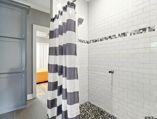 a bathroom with a shower and a sink
