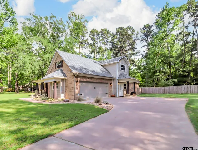 a front view of a house with a yard table and chairs