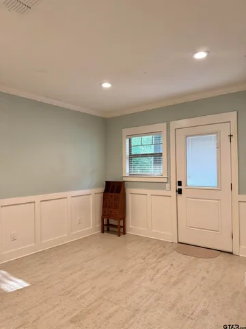 an empty room with windows and closet