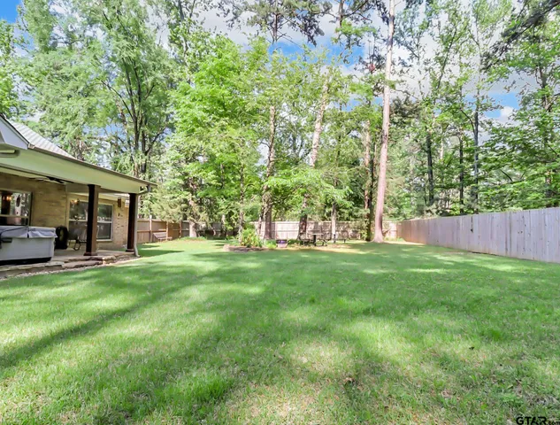 a view of a house with a backyard and porch