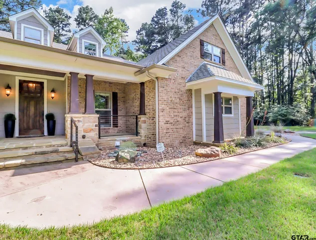a front view of a house with a yard table and chairs