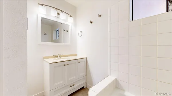 a bathroom with a sink a toilet and mirror